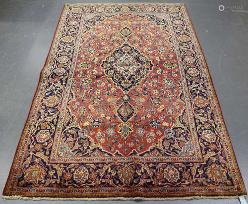 A Kashan rug, Central Persia, mid-20th century, the pink field with a stepped blue medallion,