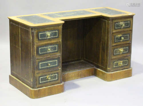 A 20th century Victorian style walnut inverted breakfront writing desk, fitted with eight oak-