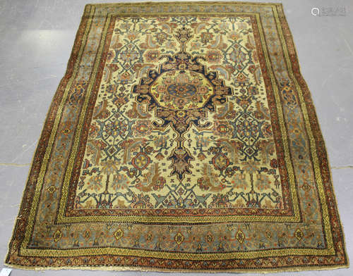 A Central Persian rug, early 20th century, the ivory field with a shaped medallion, supported by