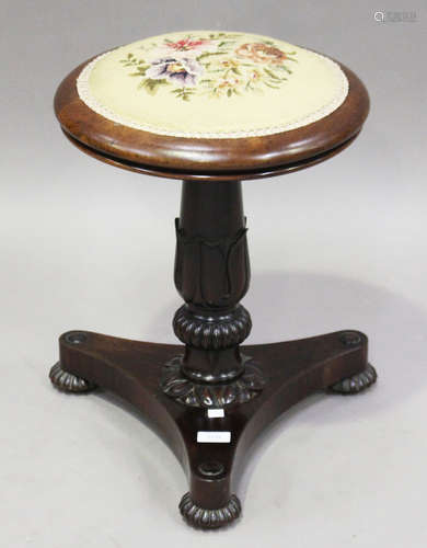 A Regency rosewood circular piano stool, the floral tapestry seat above a tulip cusp stem and