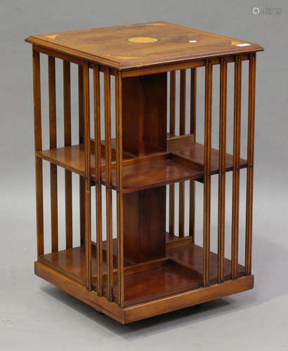 A late 20th century reproduction yew revolving bookcase with inlaid fan patera, height 80cm, width