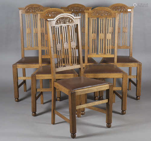 A set of six Edwardian Arts and Crafts oak framed dining chairs, possibly by Wylie & Lochhead, the