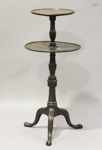 An early 20th century George III style mahogany two-tier dumb waiter, raised on tripod legs,