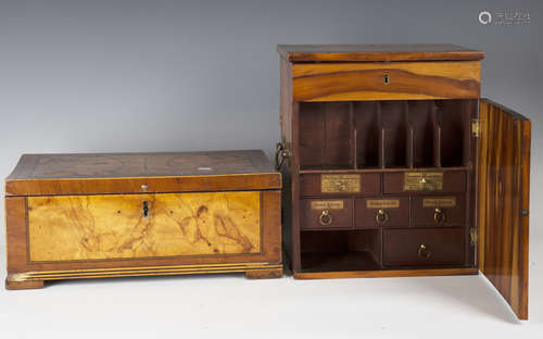 A George III hardwood apothecary's cabinet, the hinged lid above a front and rear door, all