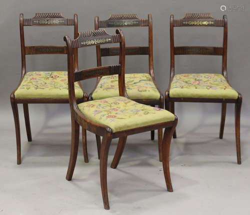 A set of four Regency stained beech and brass inlaid dining chairs with drop-in seats covering caned