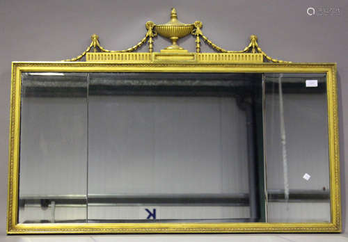 A 20th century Neoclassical giltwood wall mirror with a sectional plate glass and flaming urn