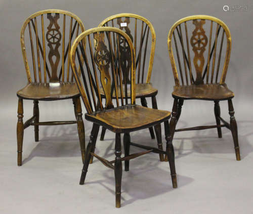 A harlequin set of four early Victorian ash and elm stick and wheel back Windsor dining chairs,