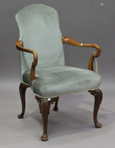 An early 20th century Queen Anne style walnut framed shepherd's crook elbow chair, raised on