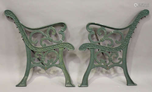 A pair of early 20th century green painted cast iron garden bench ends of scrolling form, height