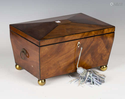 A Regency figured mahogany workbox of sarcophagus form with overall ebony stringing, the interior