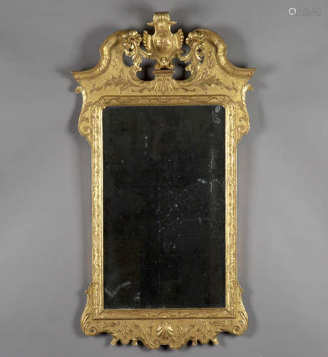 A fine George II style carved giltwood and gesso wall mirror, probably 19th century, the shaped