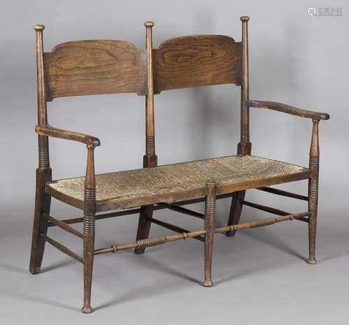 An Edwardian Arts and Crafts ash two-seat settee, designed by E.G. Punnett and made by William