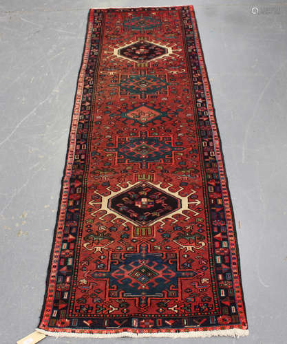 A Karajar runner, North-west Persia, mid-20th century, the pink field with a column of hooked