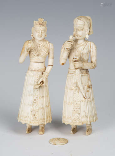 A pair of 19th century Indian carved ivory full-length figures of a lady and gentleman, height 18cm,