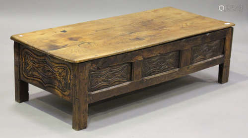 A 20th century French oak coffee table with hinged top, on block legs, height 42cm, width 140cm,