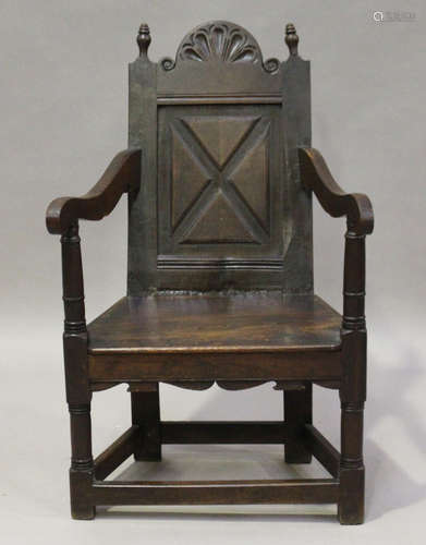 A 19th century oak Wainscot armchair, the panelled back above a solid panel seat, height 98cm, width