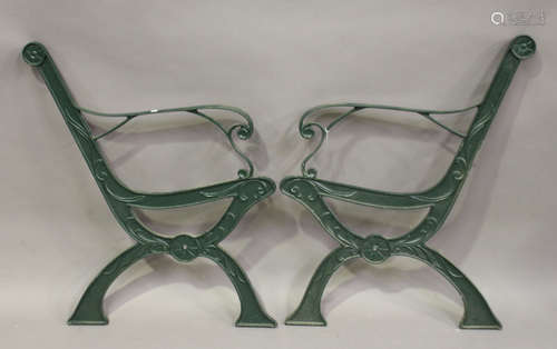 A pair of 20th century green painted cast iron garden bench ends of 'X' frame form, height 81cm,