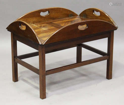 A late 20th century reproduction mahogany butler's tray coffee table, fitted with brass hinged