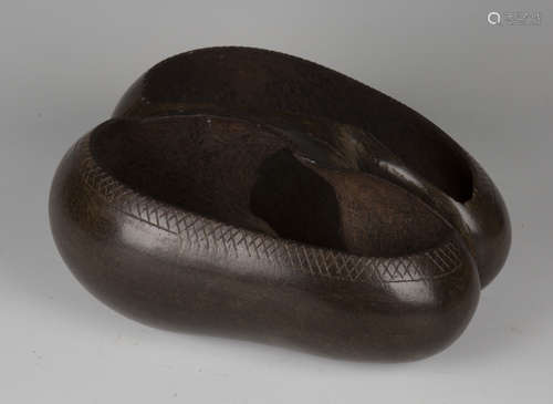 An early 20th century coco-de-mer nut, carved as a two-section bowl with central handle, length