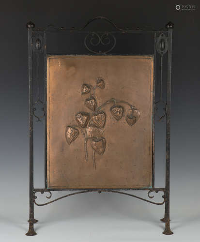 An early 20th century wrought iron and patinated copper firescreen, the copper panel worked in