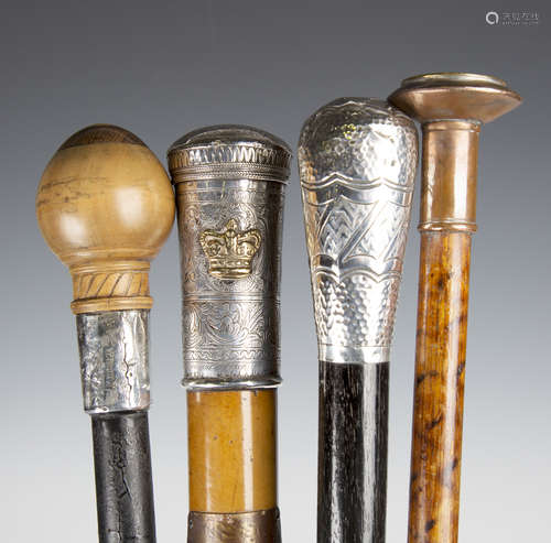 A group of four walking canes, including a 19th century Malacca walking cane with Burmese engraved