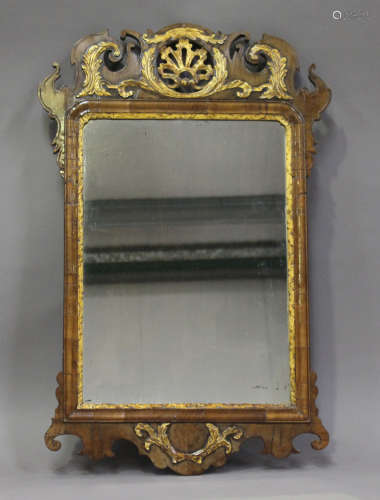 A George III walnut and gilt fretwork wall mirror, the cushion section frame with a pierced and