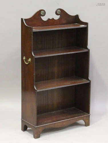 A 20th century reproduction mahogany open waterfall bookcase, the sides with applied brass