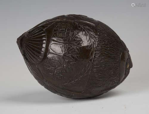 A 19th century carved coconut bugbear powder flask, one end typically worked with a mask with