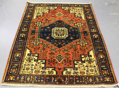 A Nahawand rug, North-west Persia, mid-20th century, the burnt sienna field with a lozenge medallion