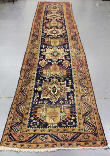 A Hamadan runner, North-west Persia, mid-20th century, the ink blue field with a column of