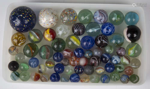 A selection of approximately sixty glass marbles, diameters ranging from 1.4cm to 4.4cm.Buyer’s