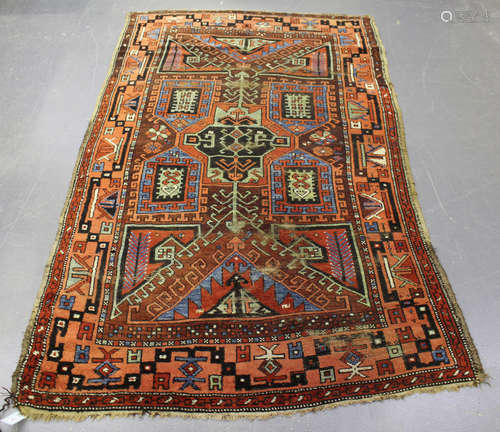 A Kazak rug, West Caucasus, early 20th century, the claret field with a central angular medallion,