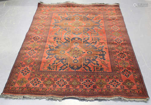 A Pakistan rug, late 20th century, the deep claret field with two eagle medallions, within a