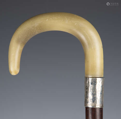 An early 20th century hardwood rhino horn handled walking stick with silver collar, London 1924,