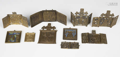 A collection of mainly late 19th century Russian cast brass icons, including two blue enamelled