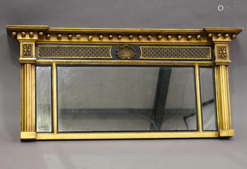 A 19th century Regency style gilt and ebonized overmantel mirror, the ballshot pediment above a
