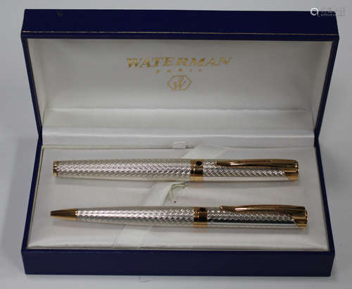 A Waterman silver and gilt metal pen set, comprising roller ball and ballpoint, cased.Buyer’s