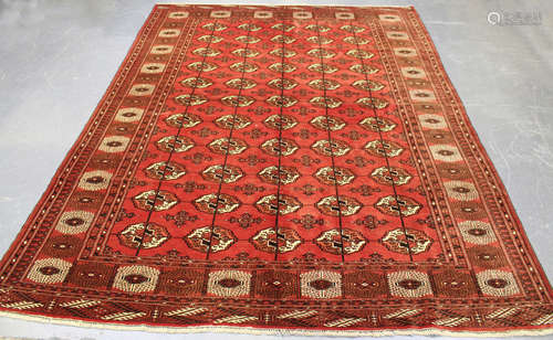 A Tekke carpet, West Turkestan, mid-20th century, the red field with five columns of guls, within