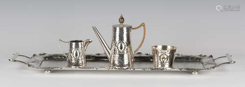 An Edwardian Arts and Crafts style plated cabaret set by Mappin & Webb, comprising teapot, milk jug,