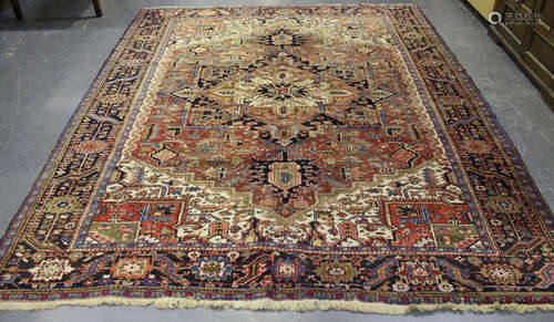 A Heriz carpet, North-west Persia, mid-20th century, the faded terracotta field with a bold