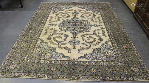 A Yadz carpet, Central Persia, mid-20th century, the ivory field with a scrolling tendril medallion,