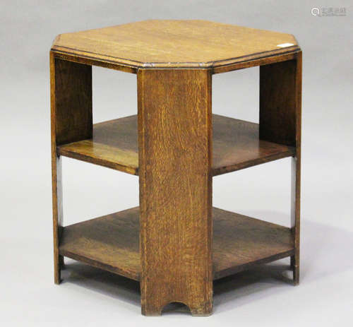 An early 20th century oak canted square book table, in the manner of Heals, height 61cm, width