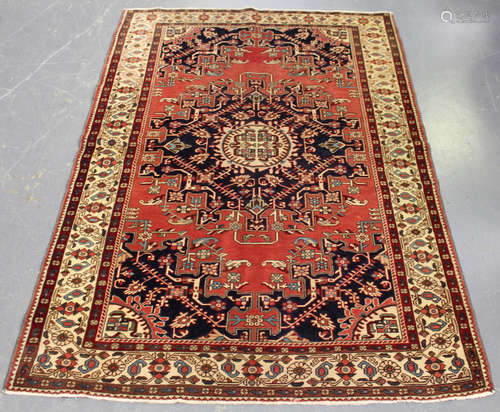 A Tafresh rug, North-west Persia, mid-20th century, the pale claret field with a midnight blue