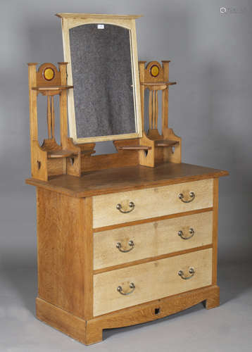 An Edwardian Arts and Crafts oak dressing chest by Shapland & Petter of Barnstaple, the swing mirror