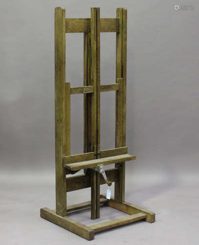 A mid-20th century limed oak artist's easel with chain-driven rising mechanism, height 165cm,