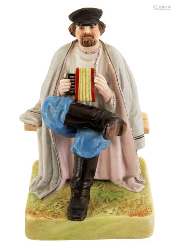 A RUSSIAN PORCELAIN FIGURE OF AN ACCORDION PLAYER, GARDNER PORCELAIN FACTORY, VERBILKI, MOSCOW, 1870