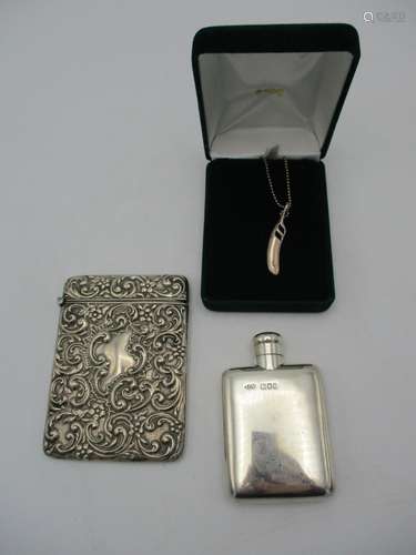 An Edward VII silver card case by Henry Matthews, Birmingham 1902, designed with embossed acanthus c