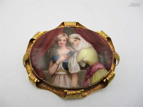 A Continental style hand painted porcelain brooch, of oval form depicting two women, one dressed