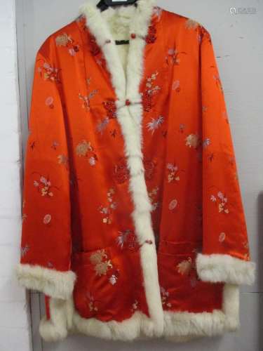 A 1970's custom made red silk ladies jacket purchased in Hong Kong having a foliage design and a