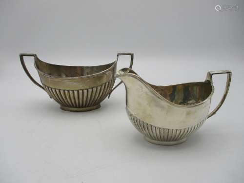 A matched pair of Edwardian silver sugar bowl and cream jug, both by Daniel George Colling,